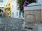 Greece Tinos island, Chora town. Cyclades street faucet, cobblestone street, bougainvillea