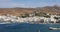 Greece Tinos island Cyclades. View from ship of Chora town cafe, building, port, sea, blue sky