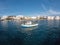 Greece, Tinos island Hora vacation Cyclades. View from ship of port moored fishing boat, sea, sky