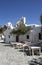 Greece â€“ Folegandros. An old square with taverna tables and a church.