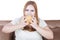 Greedy blonde woman eats hamburger