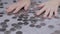 Greedy Female Hands are Stirring a Pile of Scattered Ukrainian Coins on Table