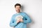 Greedy smiling man showing money and looking right, thinking about shopping, standing over white background