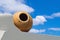 Greek amphora under blue sky on traditional balcony