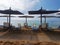 Greek Beach with wooden umbrellas