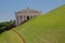 Greek building behind green grass slope, Bahai gardens, Israel