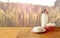 Greek cheese , bulgarian cheese and milk on wooden table over wheat field background. Symbols of jewish holiday - Shavuot