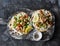 Greek chicken gyros flatbread on a rustic cutting board on a dark background, top view