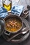 Greek chickpea soup on the stone background vertical