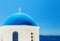 Greek church with blue dome near sea in Oia town, Santorini island, Greece