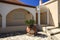 Greek courtyard decorated with clay pitcher and palm tree