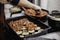 Greek dish in a baking tray standing on the stove