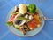 Greek fast food - fish, broccoli, mushrooms on plate