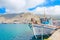 Greek Fishermans\' boat standing in harbour with port bui