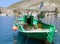 Greek Fishing Boat with Greek Flag and Yellow Fishing nets moored in Kastellorizo