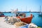 Greek fishing boat stays parked near sea pier at Vlychada town on Santorini island