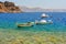 Greek fishing boats at aquamarine transparent sea