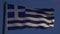 Greek flag fluttering against evening sky