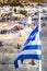 Greek flag over Paros harbor with wind mill, Cyclades, Greece. Theme of Cyclades.