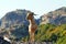 Greek goats roam free on the rugged rock formations of Meteora with the Monasteries in the background