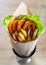 Greek gyros with fried squid rings breaded, tzatziki sauce, vegetables