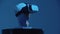 A greek head sculpture in VR glasses on the stand - blue lighting