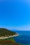 Greek island paradise beach, blue sea and pine tree. Mediterranean sea beach, evergreen pine and blue water, Greece island.