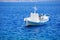 Greek landscape with a white fishing boat