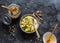 Greek natural yogurt with tropical fruits and granola on a dark background, top view. Natural yogurt with kiwi, mango and  peanut