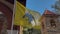 Greek orthodox flag flying in the wind. Yellow, with the double headed eagle, churchyard 2, high church tower