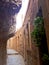 Greek Orthodox monastery in a rock on mountain of temptations. Pilgrimage to the Holy Land, vertical photo of a corridor of caves
