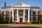 greek revival mansion with red brick and white columns