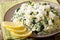 Greek rice with spinach, lemon zest, onion and feta cheese close
