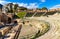 Greek and Roman Teatro antico Ancient Theatre with cavea seating auditorium in Taormina at Ioanian sea shore of Sicily in Italy