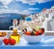 Greek salad against famous church in Oia village, Santorini island in Greece