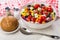 Greek salad in bowl, napkin, salt, pepper, bread in saucer