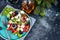 Greek salad. Diced tomatoes, cucumbers, feta cheese, olives.