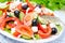 Greek salad with feta cheese, olives and vegetables, horizontal