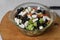 Greek salad of fresh cucumber, tomato, sweet pepper, lettuce, feta cheese and olives with olive oil