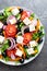 Greek salad. Fresh vegetable salad with tomato, onion, cucumbers, pepper, olives, lettuce and feta cheese. Greek salad