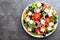 Greek salad. Fresh vegetable salad with tomato, onion, cucumbers, pepper, olives, lettuce and feta cheese. Greek salad