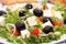 Greek salad with gigantic black olives, sheeps cheese