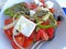 Greek salad on a platter. Healthy salad with fresh vegetables and cheese.