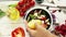 Greek salad preparation process: a cook squeezes lemon to add lemon juice