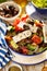 Greek salad. Traditional Greek salad consisting of fresh vegetables such as tomatoes, cucumbers, peppers, onions, oregano and oliv