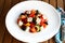 Greek salad on a white plate, horiatiki salata