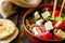 Greek salad on a wooden background. Tomatoes, peppers, olives, cheese, onions. Healthy eating. Diet. Vegetarian food