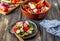 Greek salad on a wooden background. Tomatoes, peppers, olives, cheese, onions. Healthy eating. Diet. Vegetarian food