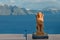 Greek sculpture of the Sphinx on the island of Santorini on the background of the sea.