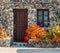 Greek stone house with geranium flowers
